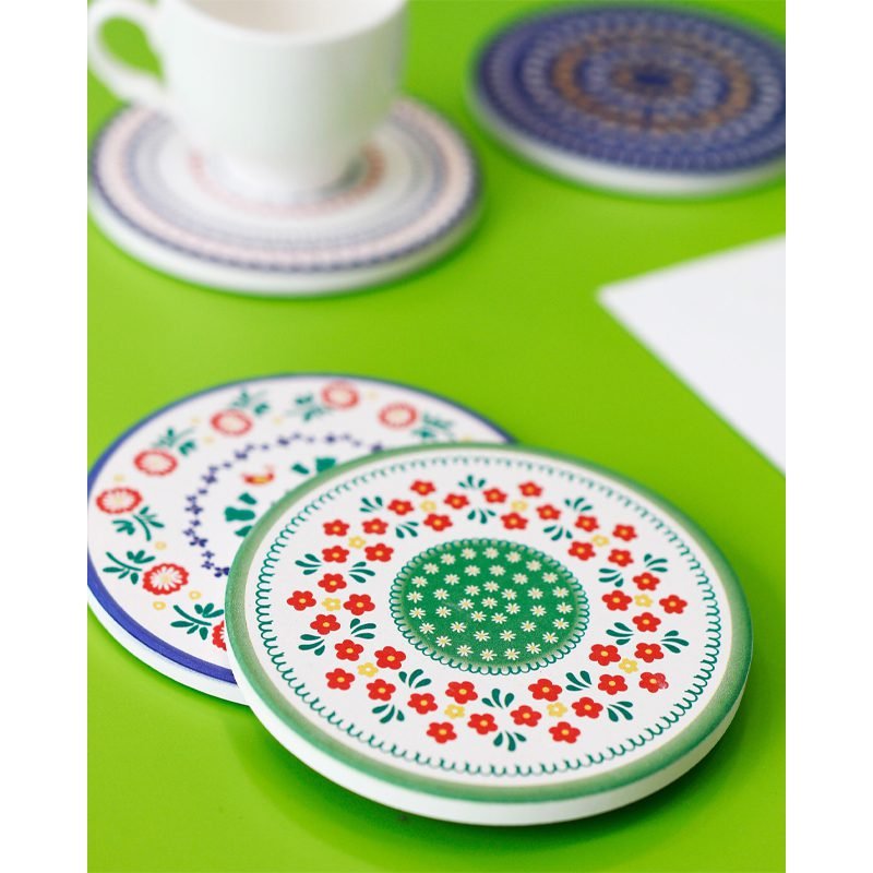 A porcelain coaster 4 pcs set with a plastic holder.